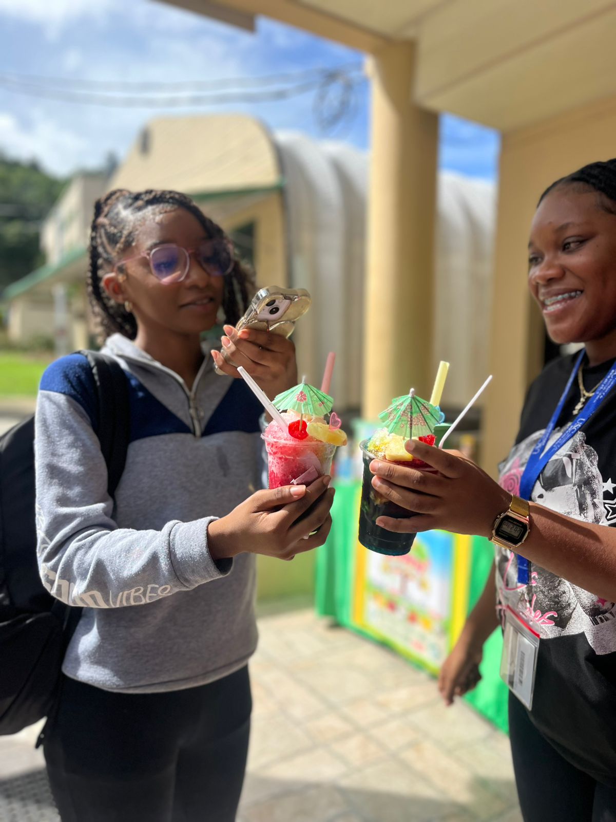 A vibrant specialty snow cone served inside a hollowed pineapple, generously topped with condensed milk, cherries, and colourful syrups