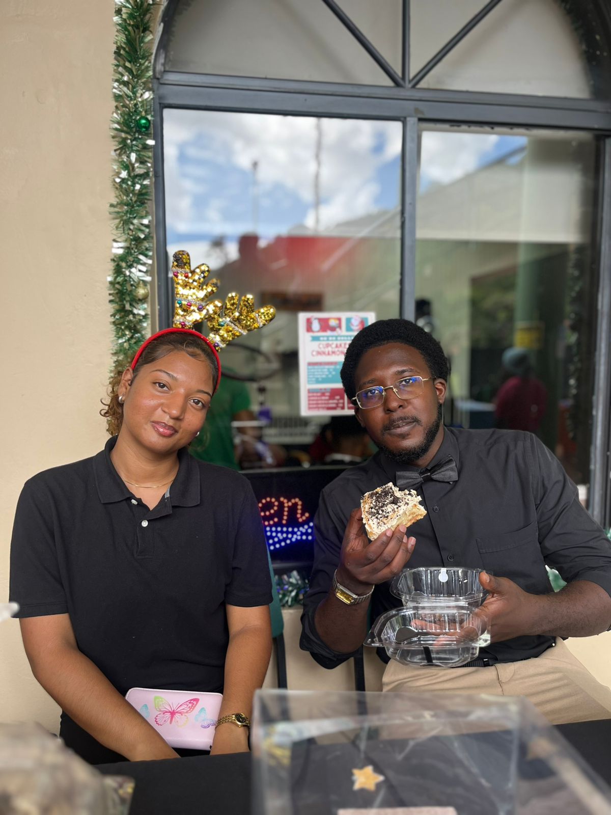 A student entrepreneur interacting directly with patrons and discussing their custom business offerings at a vendor booth