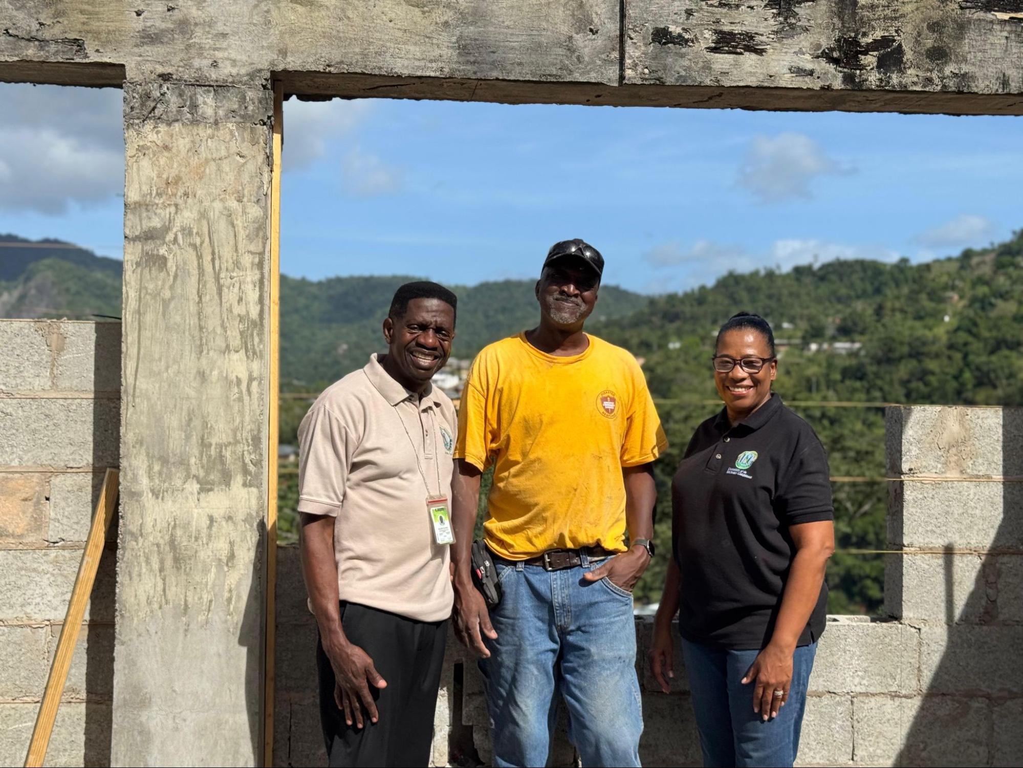 USC President Dr Colwick Wilson, volunteer leader Martin John, and Dr Deleise Cole-Wilson at the construction site