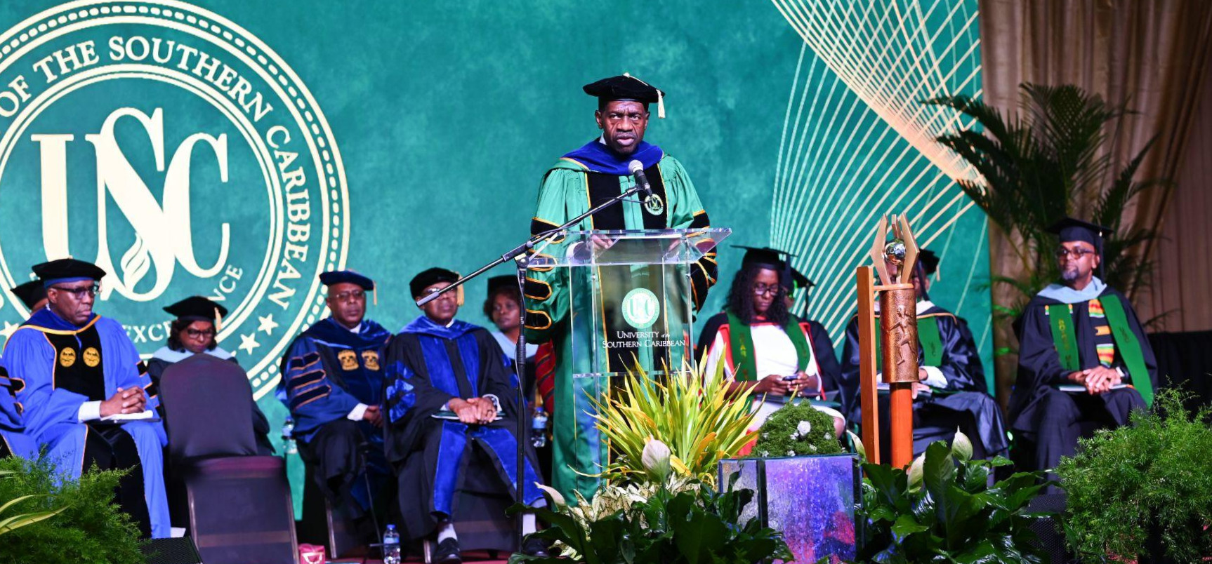 USC President Dr Colwick Wilson standing at the podium addressing the audience during the graduation ceremony.