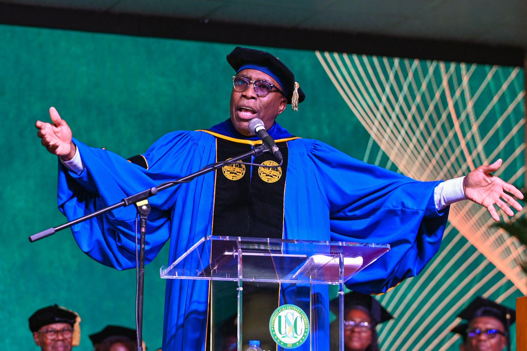 Keynote speaker Dr Christon Arthur speaking passionately from the podium during the USC 93rd Commencement Ceremony.