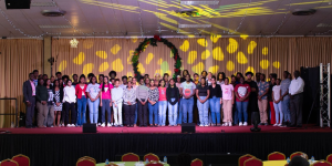 New university students on stage at the USC 2026 orientation programme, joined by President Dr Colwick Wilson (far left) and VP of Student Services and Enrolment Management Ps. Onesi La Fleur (far right).